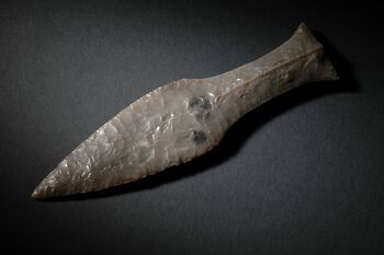Denne flintdolken ble funnet på Rennesøy i Rogaland. Slike flintdolker var gjerne modellert etter dolker i metall og regnes som det nærmeste man kommer en salgssuksess i forhistorien. Les mer om flintdolkene . Foto: Terje Tveit/Ar­keo­logisk museum, Uni­versi­tetet i Stavanger/ CC BY-NC-ND 3.0