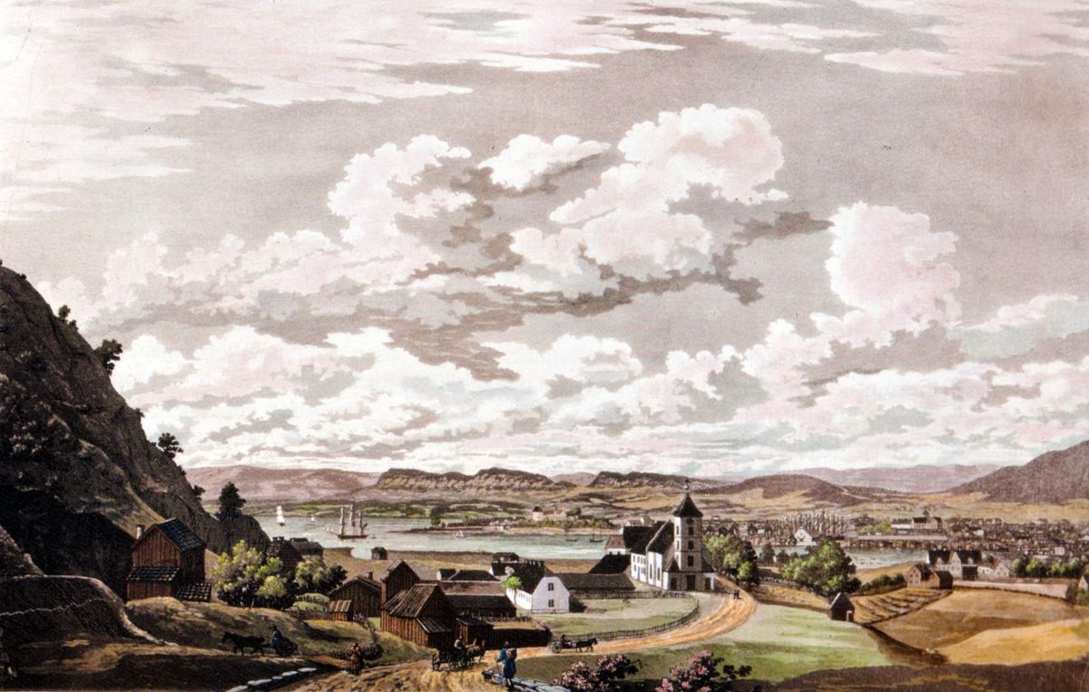 Maleri, utsikt mot Oslo fra Ekeberg: jorder og ubebygde sletter omkranser en liten by.
