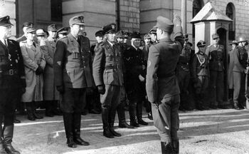 Framtredande personar i NS og norsk politi utanfor slottet i september 1944. Frå venstre i framre rekke ser me Jonas Lie, Vidkun Quisling og Karl A. Mathisen. Les meir om norsk politi under andre verdskrig . Foto: ukjent/Arbeiderbevegelsens arkiv og bibilotek/ CC BY-NC-ND