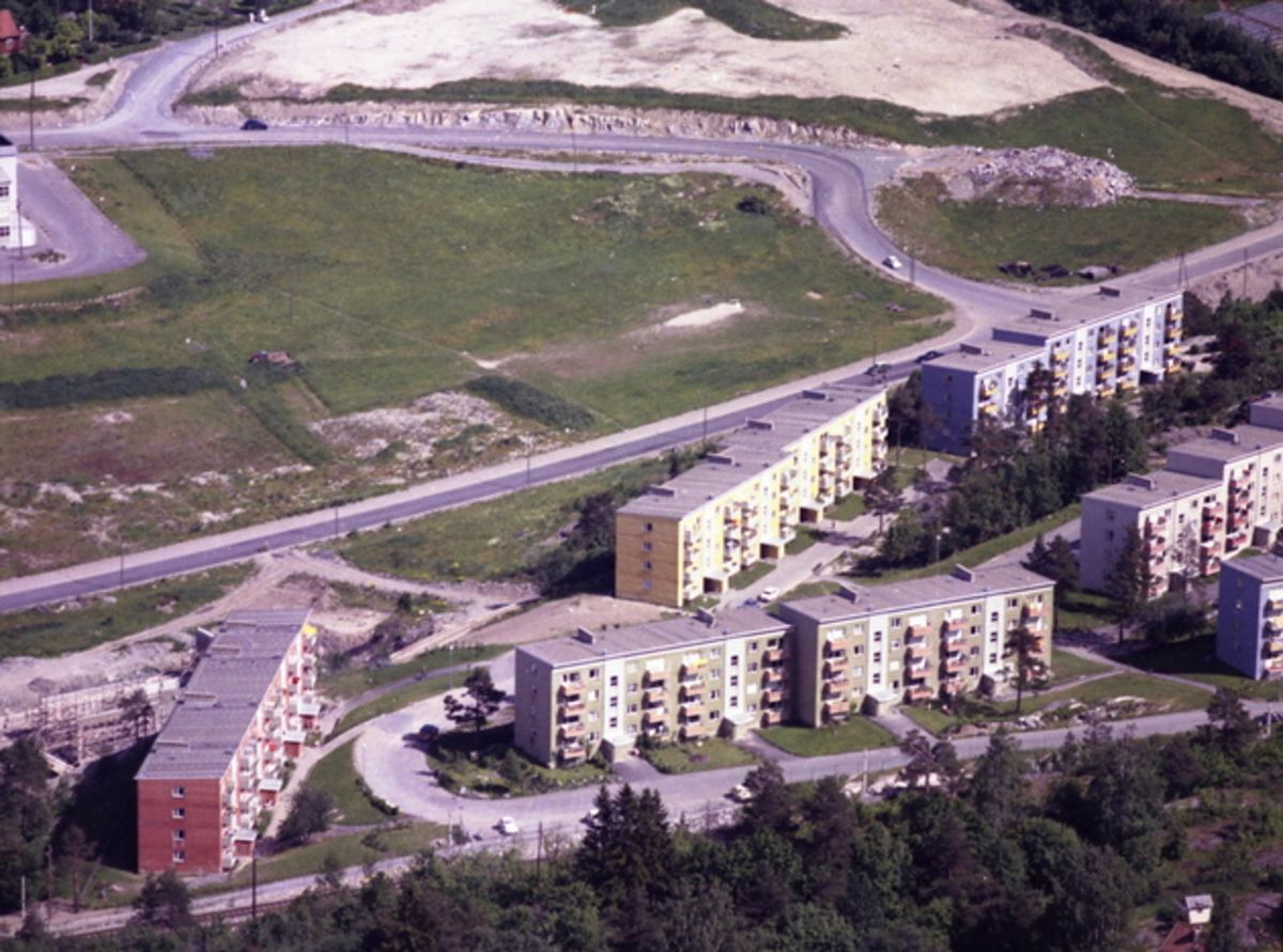 Flyfoto av boligblokker ved hovedvei